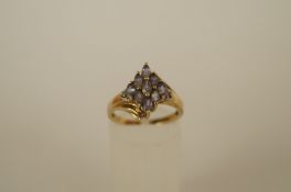 A nine stone tanzanite 9ct gold cluster dress ring with a small single cut diamond to each shoulder,