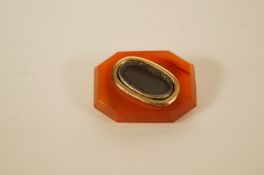 A William IV hair panel mourning brooch, the oval glazed panel to a rectangular cut corner agate