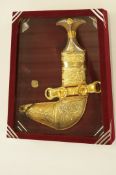 An Arabian gold plated presentation dagger, cased