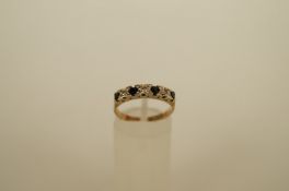 A seven stone sapphire and diamond 9ct gold half eternity ring, the four round cut sapphires with