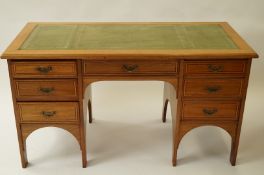 A 20th century beech desk with leather insert