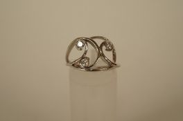 A three stone diamond 18ct white gold dress ring, the brilliant cut totalling approximately 0.3ct,