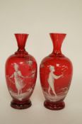 A pair of ruby red cased cameo glass by Mary Gregory