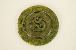 An oriental carved jade pendant of a dragon