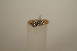 A two stone diamond 9ct gold ring, the illusion set brilliants totalling approximately 0.06cts,