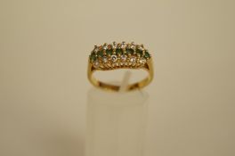 An emerald and cubic Zirconia half hoop ring, the stones arranged in three rows, finger size O, 4.3g