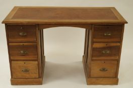 A beech pedestal desk with faux leather insert