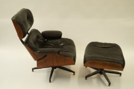 WITHDRAWN A Charles Eames, black leather lounger chair and footstool.
