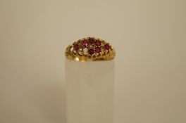An Edwardian ruby and diamond 18ct gold ring marks rubbed, the seven rubies, one setting vacant,