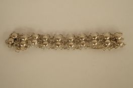 A collection of silver coloured earrings and a bracelet, probably continental