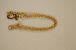 A letter "J" pendant stamped 9ct on a chain, pendant 1.1cm long and chain 42cm long,  1g gross,