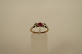 A three stone synthetic set ring, finger size N 1/2, 2.4g gross