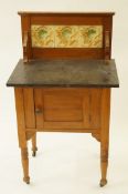 A 1921 marbled topped washstand topped washstand with 3 tiled inset