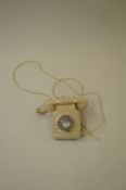 A cream white plastic telephone
