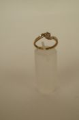 A diamond single stone ring, the illusion set single cut to a 9ct gold over mount, finger size N,
