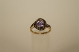 A synthetic stone and diamond dress ring, stamped "14ct" the lilac synthetic enclosed to a