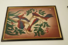 A pair of oriental paintings on silk depicting birds on branches
