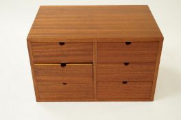 A large six draw teak coin collectors cabinet and quantity of coin sleeves