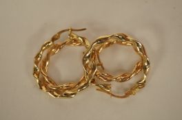 A pair of hoop earrings, of twisted design, with another similar pair, all stamped "375" 2.2g gross