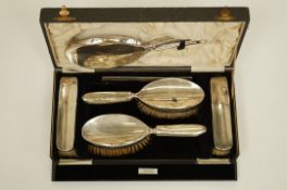 A silver backed dressing table set