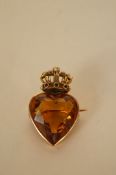 A Victorian citrine crowned heart brooch, the madeira coloured stone with a ruby emerald and seed