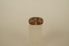 A 9ct gold eternity ring, set with synthetic stones, finger size N 1/2, 3.4g gross