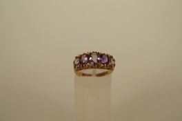 A five stone 9ct gold amethyst dress ring, the graduated oval cuts to a modern carved head mount,