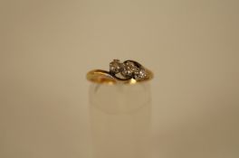 A three stone diamond ring, the graduated brilliant cuts totalling approximately 0.2cts estimated,