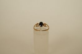 A single stone sapphire 9ct gold ring, the oval cut between beaded shoulders, finger size N 1/2,