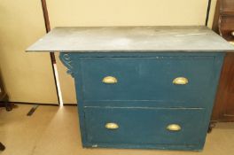 A chest of painted drawers with a slate top