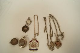 A Victorian oval locket, with applied monogram, with a silver watch chain, fob attached, a Victorian