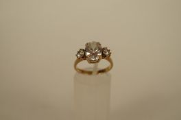 A three stone cubic zirconia 9ct gold dress ring, finger size N, 3.9g gross