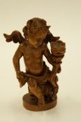A carved wooden figure of a cherub