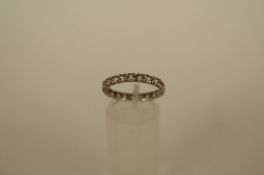 A synthetic spinel set eternity ring, finger size P, 2.3 grams