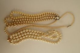 A two row simulated pearl necklace, another similar and a single row necklace