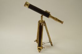 A telescope with brass and leather mounts on tripod stand