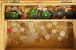 A collection of various coins in a pine box