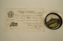 A five pound note with paper weight