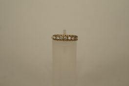 A seven stone cubic zerconia 9ct gold half hoop ring, finger size L 1/2, 2.2g gross