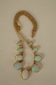 A reconstituted opal set necklace, the nine graduated oval cabochons to a 9ct gold belcher link