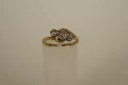 A three stone diamond 9ct gold ring, the illusion set brilliant cuts totalling approximately 0.