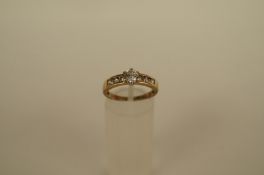 A cubic zirconia dress ring, the central stone between channel set shoulders, finger size M 1/2, 2.2