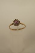 A pink tourmaline and diamond cluster ring, the round round cut stone, 4mm in diameter, to a