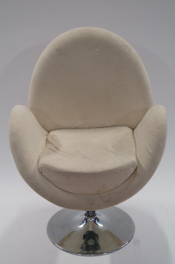 A cream egg shape swivel chair