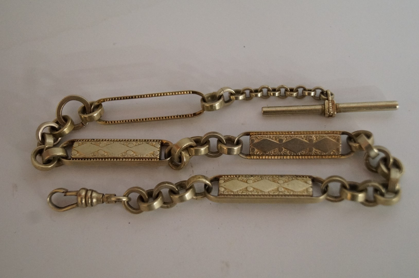 A metal watch chain of fancy links, approx 34.5cm long
