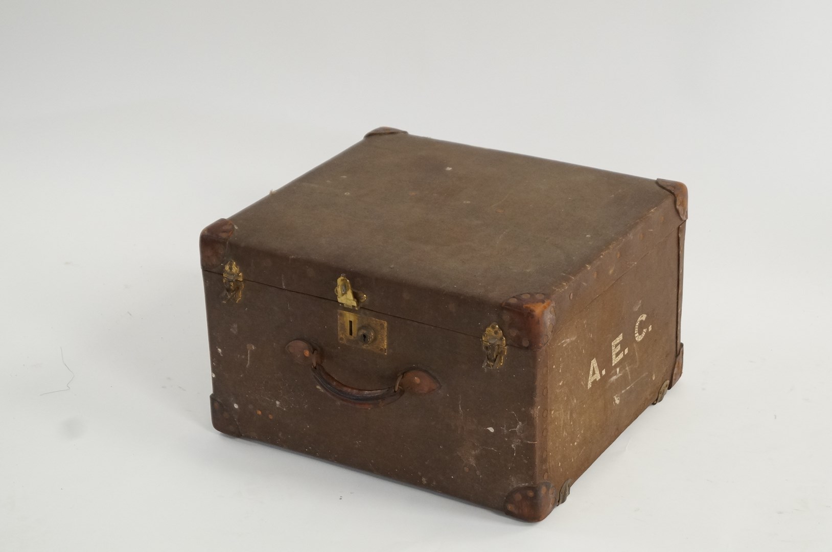 An early 20th century travelling trunk. with leather handle and fitting. Harrods label to the