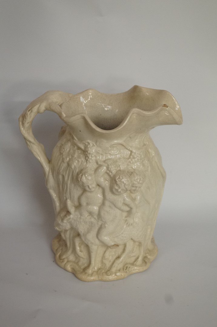 A decorative 19th century ceramic silenus jug
