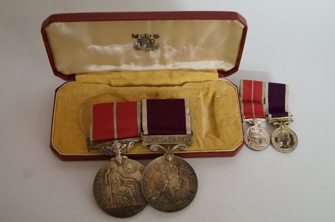 Two ERII medals to include a meritorious service and regular army medal, and matching miniatures,