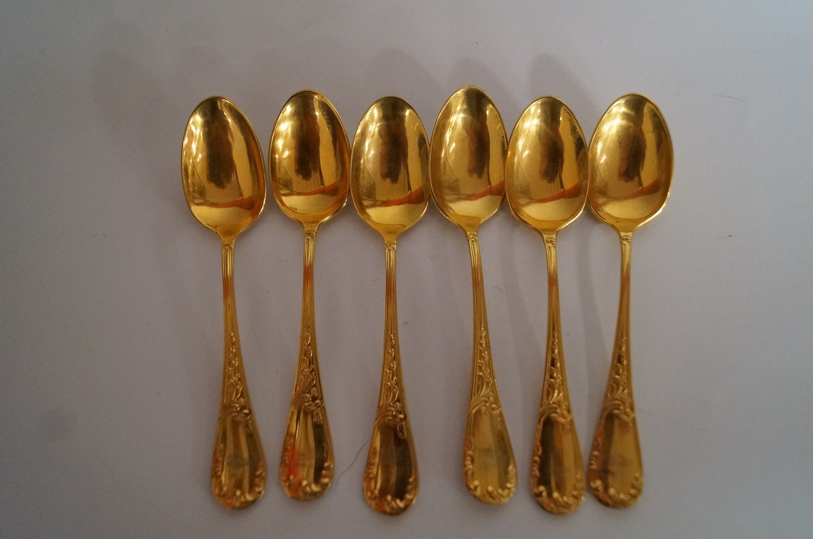 A set of six gold plated metal coffee spoons