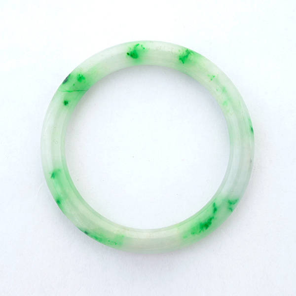 Jade Bracelet. The carved jadeite bangle measuring approximately 8 mm with a 51 mm internal